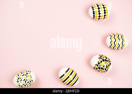 Golden Easter eggs with geometric design on pink background. Easter card with copy space for text. Minimal easter concept Stock Photo