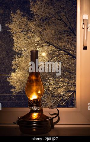 Kerosene lamp on the windowsill Stock Photo