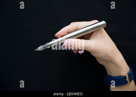 Silver microblading pen for eyebrow on black background Stock Photo