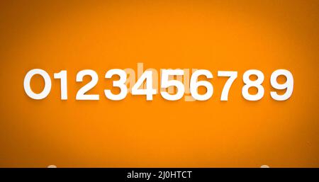 Mathematics background made with solid numbers. Isolated on orange Stock Photo