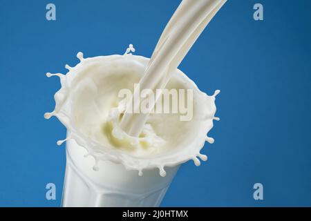 Pouring milk splash in glass, top view Stock Photo