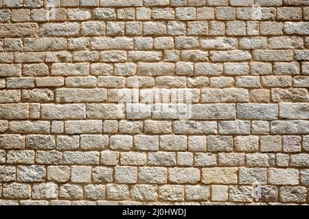 Background from a regular natural old stone wall Stock Photo