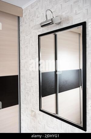 Mirror on the wall with light Stock Photo