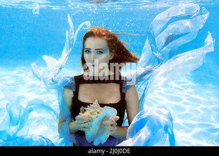 Blue fabric floating in pool Stock Photo