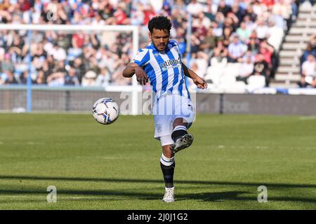 Huddersfield, UK. 19th Mar, 2022. Duane Holmes #19 of Huddersfield Town crosses the ball in Huddersfield, United Kingdom on 3/19/2022. (Photo by Simon Whitehead/News Images/Sipa USA) Credit: Sipa USA/Alamy Live News Stock Photo