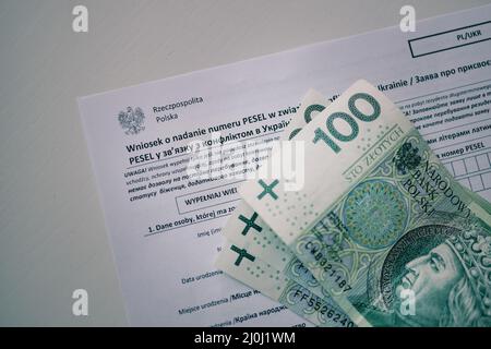 2022 Polish ID. PESEL. Personal Identification Number in Poland. Zloty and polish money and document in white table Stock Photo