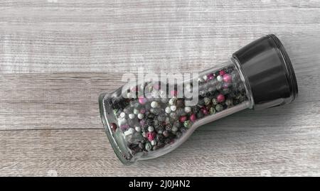 Various varieties of pepper in a glass bottle Stock Photo