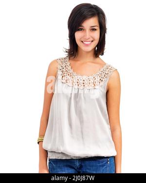 Optimistic youth representative. Pretty young woman standing casually, smiling at the camera, isolated on white - copyspace. Stock Photo