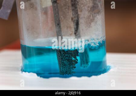 Microscale electrolysis of copper chloride solution for school science in the UK Stock Photo