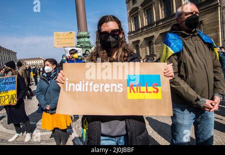 Munich, Bavaria, Germany. 19th Mar, 2022. A womsn in Munich, Germany dsiplays a sign reading ''indifference kills'', warning against war fatigue from the general public that may be settling in Despite the beginnings of ''war fatigure'' from the general public, Ukrainians and Belarusians continue to demonstrate to raise awareness of the war being waged by Russia over their land. The demonstrators are demanding Europe heed their warnings that Russia will not stop at Ukraine, bring more bloodshed with their expansion. (Credit Image: © Sachelle Babbar/ZUMA Press Wire) Stock Photo