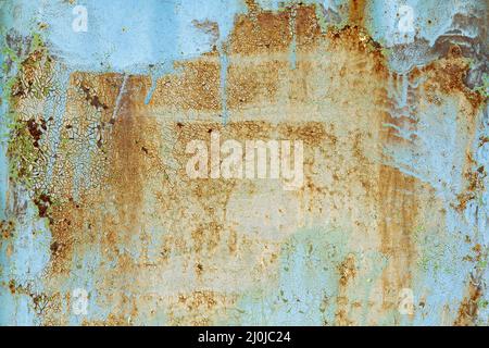 Brown beige abstract background with orange blue hues. A rust-eaten textured sheet of metal with remnants of paint marks. Stock Photo