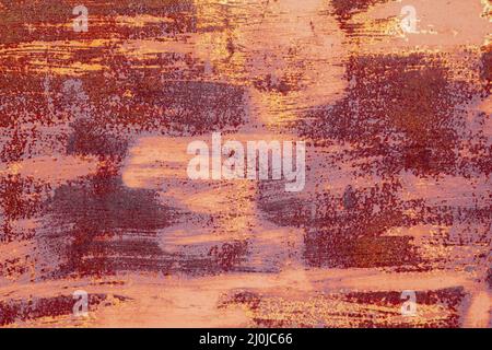 Red brown abstract  background with pink hues. A weathered, rust-eaten textured sheet of metal with traces of paint residue. Stock Photo