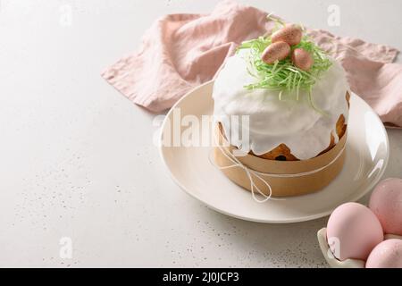 Traditional Easter cake and pink eggs on white background. Space for text. Close up. Stock Photo