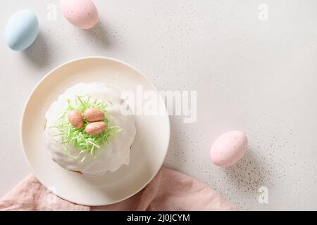 Traditional Easter cake and pink eggs on white background. Space for text. View from above. Stock Photo
