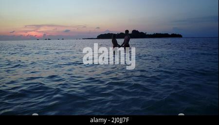 Silhouettes of a couple in the Maldives under a beautiful sunset Stock Photo