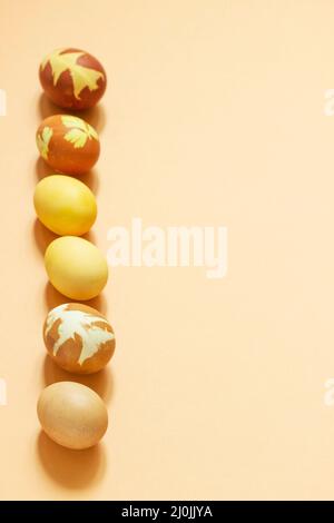 Easter eggs dyed with natural dyes, onion peel, turmeric, beetroot on a light background. Stock Photo