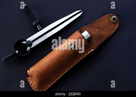 Leather knife sheath with the black background. Leathercraft tools Stock Photo