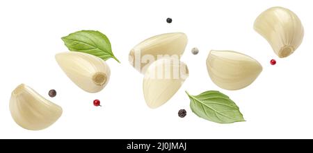 Falling peeled garlic cloves isolated on white background Stock Photo