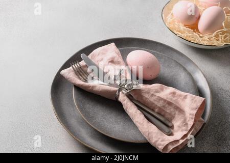 Easter dinner with pink egg, elegance table setting. Top view. Copy space. Stock Photo