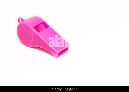 A pink plastic whistle isolated on a white background. Stock Photo