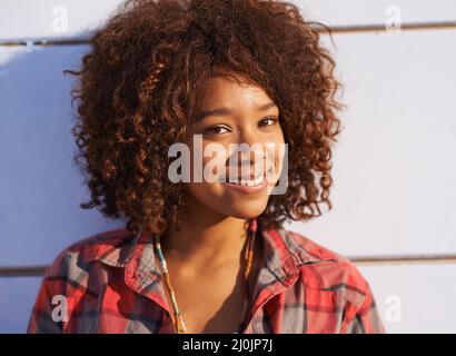 Style and personality. A trendy young woman smiling while looking at the camera. Stock Photo