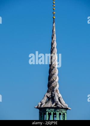 Copenhagen, Denmark - July, 2021: Spire, shaped as the tails of four dragons twined together, reaching a height of 56 metres on the Børsen -17th-centu Stock Photo