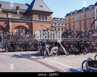 Copenhagen, Denmark - July 2021: View of Copenhagen Central Station, Copenhagen Central Station and lots of bicycles stacked at two levels on racks. E Stock Photo