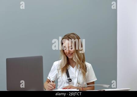 Female doctor working with her laptop in medical office Stock Photo