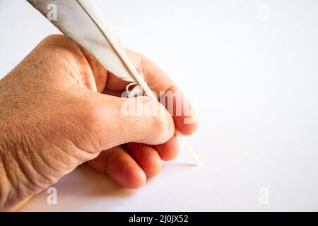 Hand writing with a bird feather Stock Photo