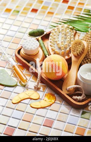 Jars of cream for face and body care, gold eye patches and serum with gold, jade roller massager gau-sha and massager and body b Stock Photo