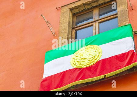 Mexican flag green white red on building sky Mexico City. Stock Photo