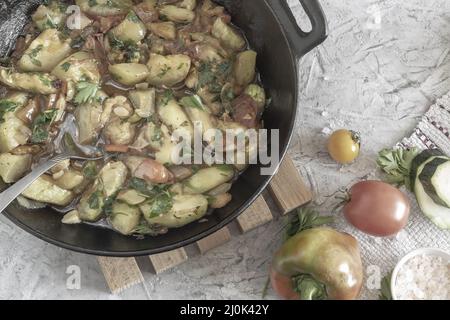Delicious fried zucchini in a cast-iron frying pan Stock Photo
