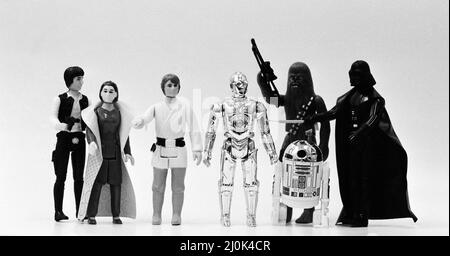 Star Wars toys. Figures from left to right, Han Solo, Leia Organa, Luke Skywalker, C-3PO, Chewbacca, R2-D2 and Darth Vader. 21st October 1982. Stock Photo