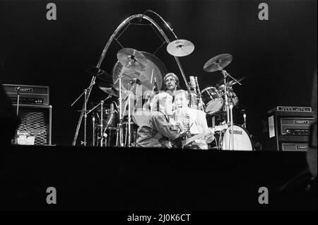British rock group The Who in Toronto, Canada.The band performing on stage at Maple Leaf Gardens, the last venue on their Farewell tour. Singer Roger Daltrey and Pete Townshend sharing a microphone with drummer Kenney Jones behind. December 1982. Stock Photo