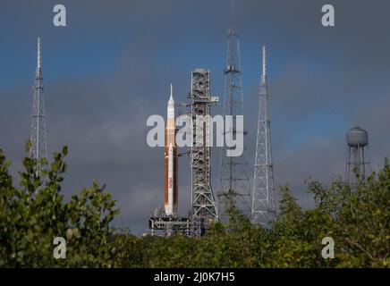 Cape Canaveral, Florida, USA. 18th Mar, 2022. After a four-mile journey traveled by many spacecraft throughout NASA's history, the Artemis I Moon rocket, NASA's Space Launch System (SLS) with the Orion spacecraft atop it, has arrived at the launch pad for the first time. In the coming days, engineers and technicians will prepare the Artemis I rocket for its final major test, the wet dress rehearsal. The approximately two-day test will demonstrate the team's ability to load cryogenic, or super-cold, propellants into the rocket, conduct a launch countdown, and practice safely removing propell Stock Photo