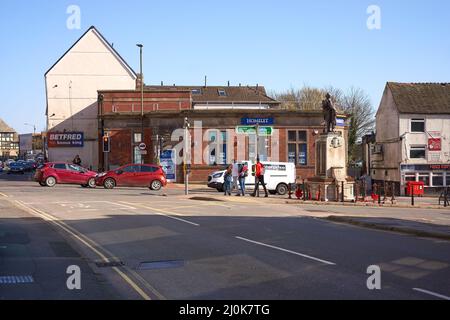 people waiting to cross a main road Stock Photo