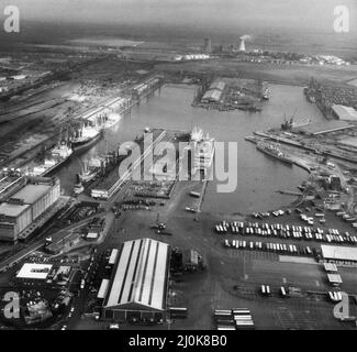 King George and Queen Elizabeth Docks, Hull seen from the cockpit of a RAF Jaguar reconnaissance aircraft travelling at 400 mph above the port.This image was taken shortly before the North Sea Ferry Norland was requisitioned for the Falklands War. It shows that vessel berthed at the ferry terminal in the centre of the picture. To the right, the Royal Navy's Exocet armed Leander Class Frigate HMS Minerva, on a port visit can be seen tied up. 7th May 1982 Stock Photo