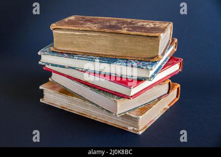 Stack of old books on dark background Stock Photo