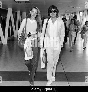 Mick Jagger and girlfriend, model, Jerry Hall, pictured at London Heathrow Airport, departing for India, 28th July 1981. Stock Photo