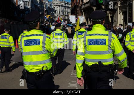 Protest taking place against vaccinating children for Covid 19, joined by anti-vaxxers. Numbers of police officers providing escort Stock Photo