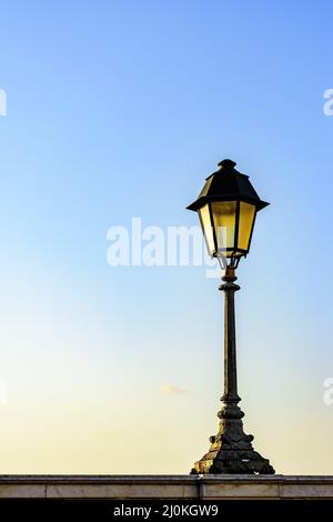 Old colonial style lamppost on the walls of the streets of Salvador Stock Photo