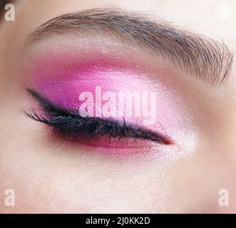 Closeup macro shot of closed human female eye. Girl with perfect skin and pink eyes shadows Stock Photo