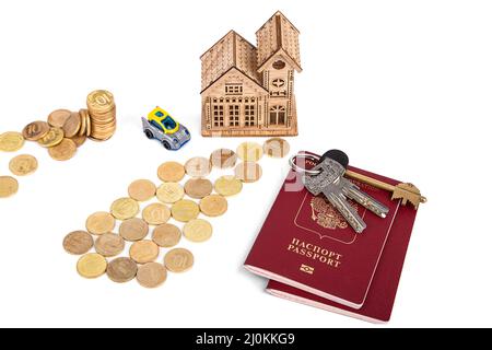 documents, house keys and a house with expensive coins on a white background Stock Photo