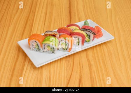 Japanese sushi set. Various types of roles on plate over stone