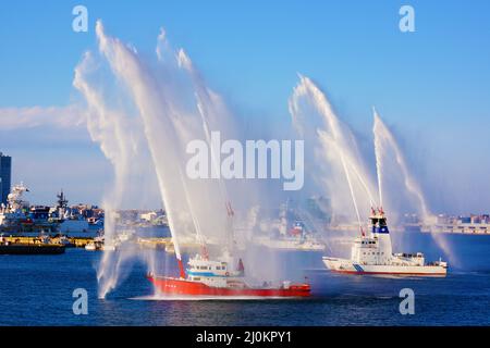 Fire fighting vessels to the water discharge training Stock Photo