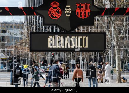 Madrid, Spain. 19th Mar, 2022. Pedestrians walk past a sign of La Liga long-standing rivalry derby game, commonly known as El Clasico, between Real Madrid and Barcelona near the Real Madrid FC Santiago Bernabeu stadium in Spain. Credit: SOPA Images Limited/Alamy Live News Stock Photo