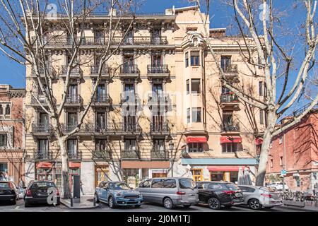 Facade of an old building with metal balustrades on the balconies on a sunny winter day in Madrid Stock Photo