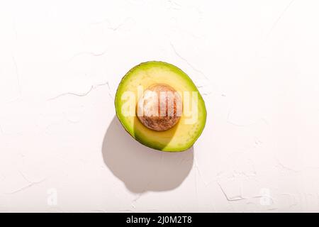 Half cut avocado on white background Stock Photo