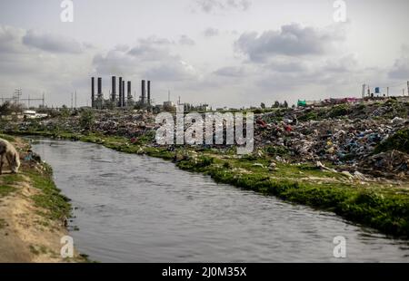 Gaza, Palestine. 19th Mar, 2022. Palestinian men work in sorting waste in the wet area of Wadi Gaza in the central Gaza Strip. In Wadi Gaza, plastic bottles and putrid water have taken the place of trees, flowers and animals. But aware of the health dangers, the local authorities are working to transform the marsh into the first natural park in the Palestinian enclave. (Photo by Mahmoud Issa/SOPA Images/Sipa USA) Credit: Sipa USA/Alamy Live News Stock Photo