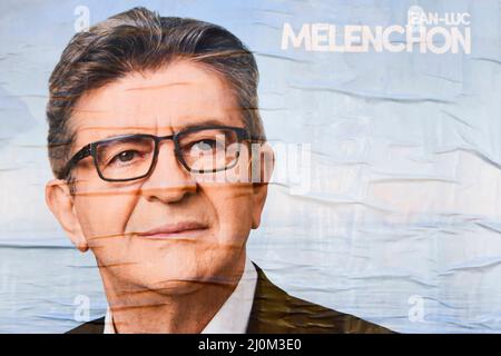 Poster of Jean-Luc MELENCHON (far-left political party La France Insoumise, LFI). Posters for the 2022 French presidential election campaign bloom on city walls, before being very quickly torn off by the opposing gluers on March 19, 2022 in Paris, France. Stock Photo